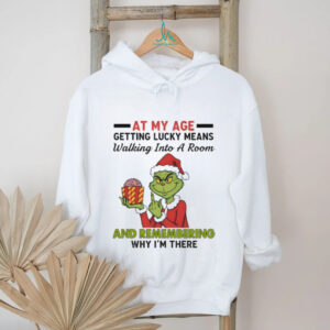 Funny Grinch Santa hat at my age getting lucky means walking into a room and remembering Merry Christmas shirt