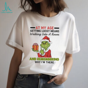 Funny Grinch Santa hat at my age getting lucky means walking into a room and remembering Merry Christmas shirt