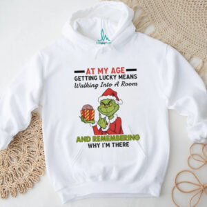 Funny Grinch Santa hat at my age getting lucky means walking into a room and remembering Merry Christmas shirt