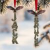 personalized Christmas ornament featuring a red bauble with a Scrabble style crossword puzzle of family names personalized Christmas ornament featuring a red bauble with a Scrabble style crossword puzzle of family names