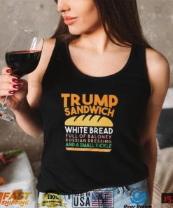 Trunp sandwich white bread full of bakone y russian dressing and a small picke shirt