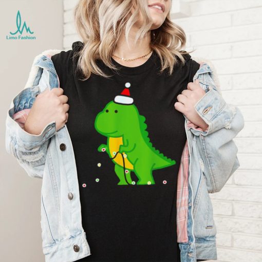 Dinosaur putting up string lights Christmas shirt