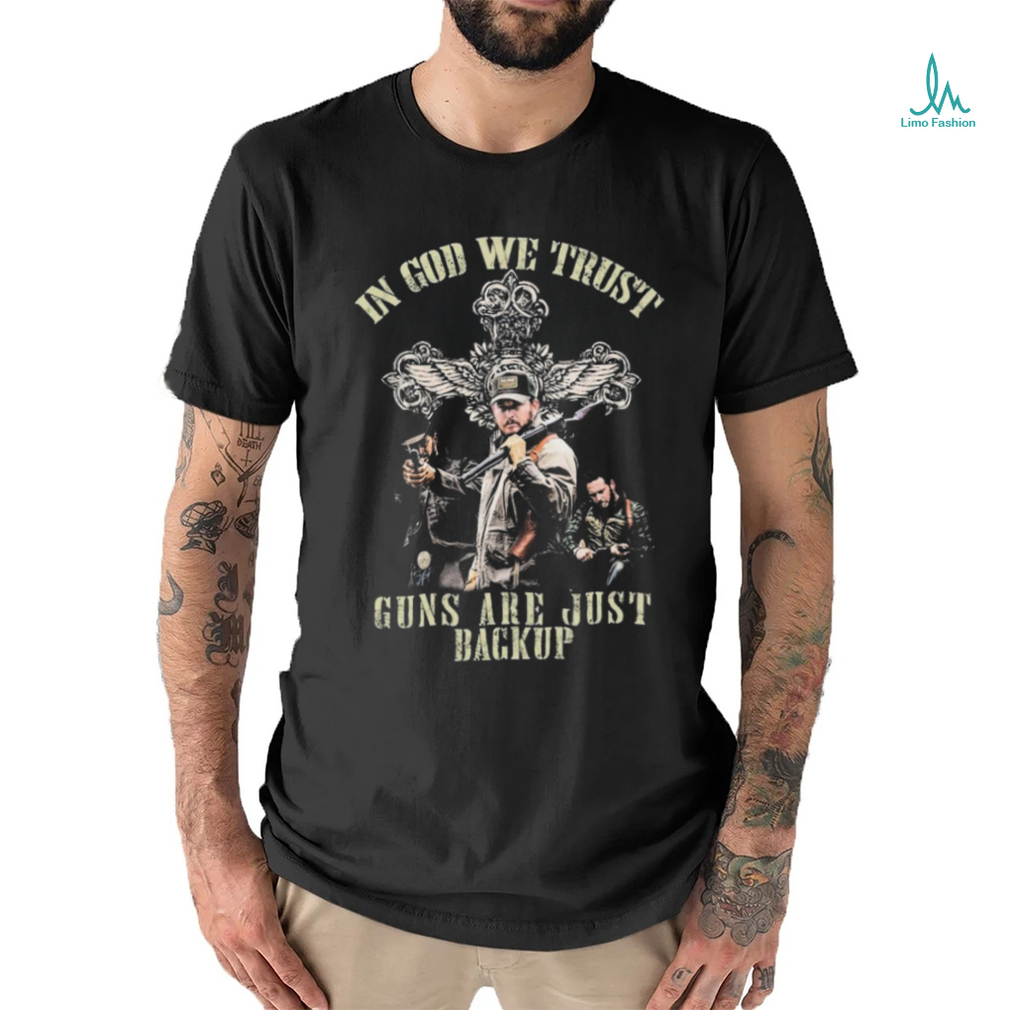 Cross and the man holding gun in god we trust guns are just backup shirt Cross and the man holding gun in god we trust guns are just backup shirt