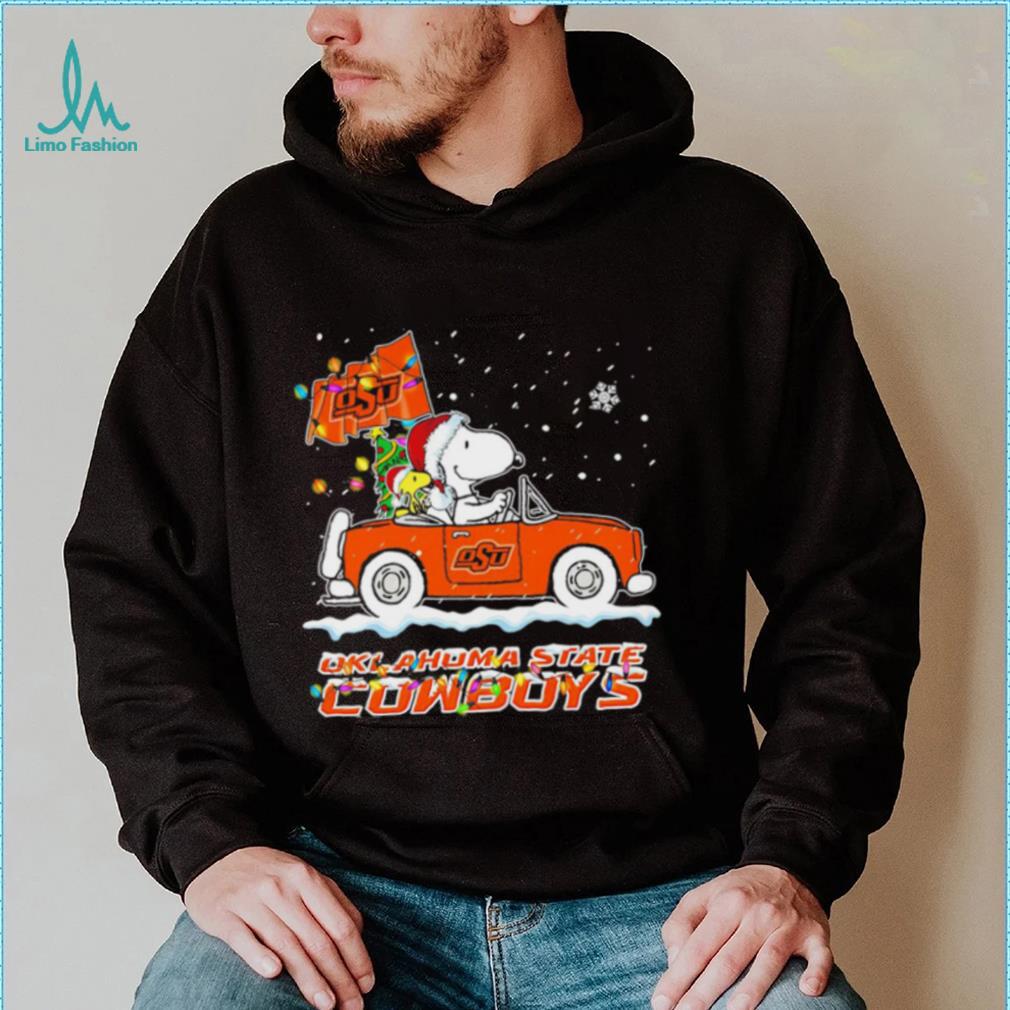 Happy Merry Christmas Snoopy drive a car Oklahoma State Cowboys logo flag gift shirt Happy Merry Christmas Snoopy drive a car Oklahoma State Cowboys logo flag gift shirt