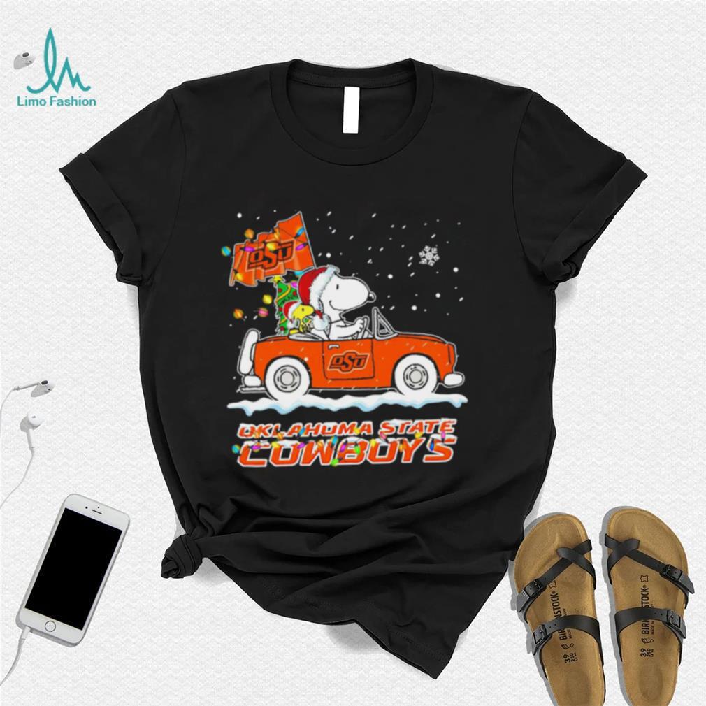 Happy Merry Christmas Snoopy drive a car Oklahoma State Cowboys logo flag gift shirt Happy Merry Christmas Snoopy drive a car Oklahoma State Cowboys logo flag gift shirt