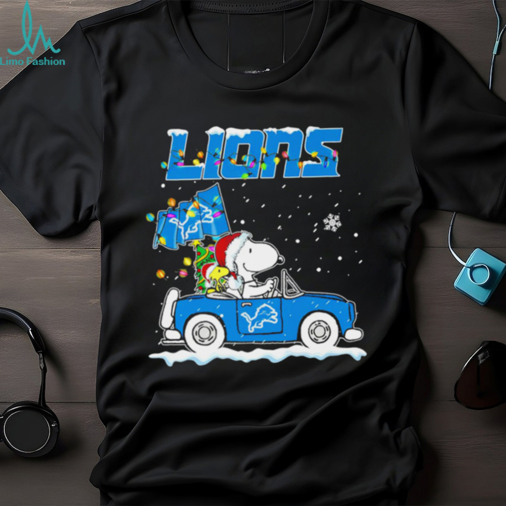 Happy Merry Christmas Snoopy drive a car Detroit Lions logo flag gift shirt Happy Merry Christmas Snoopy drive a car Detroit Lions logo flag gift shirt