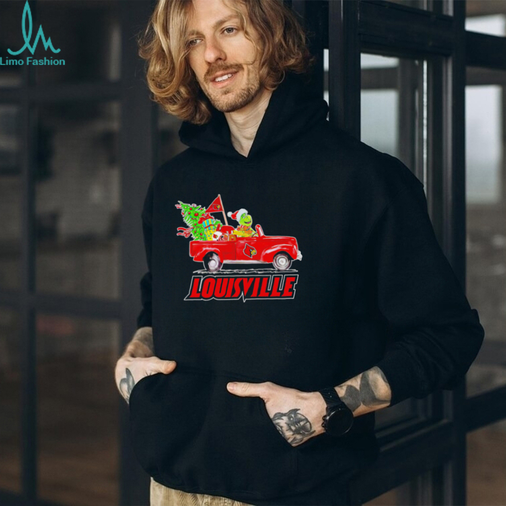Happy Merry Christmas The Grinch drive a car Louisville Cardinals football logo flag gift shirt Happy Merry Christmas The Grinch drive a car Louisville Cardinals football logo flag gift shirt