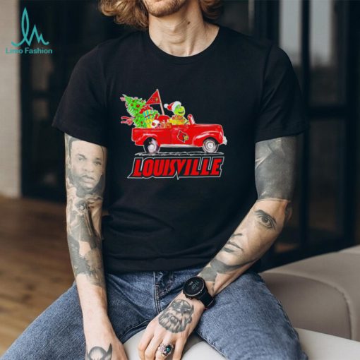 Happy Merry Christmas The Grinch drive a car Louisville Cardinals football logo flag gift shirt