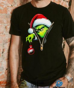 Santa Grinch insdie zipper holding Philadelphia Eagles shirt