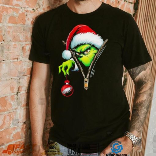 Santa Grinch insdie zipper holding Philadelphia Eagles shirt