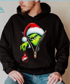 Santa Grinch insdie zipper holding Philadelphia Eagles shirt