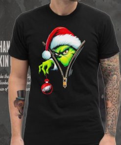 Santa Grinch insdie zipper holding Philadelphia Eagles shirt