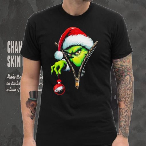 Santa Grinch insdie zipper holding Philadelphia Eagles shirt