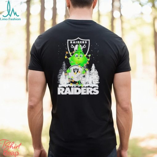 The Baby Grinch hugging Las Vegas Raiders helmet snowy forest Christmas shirt