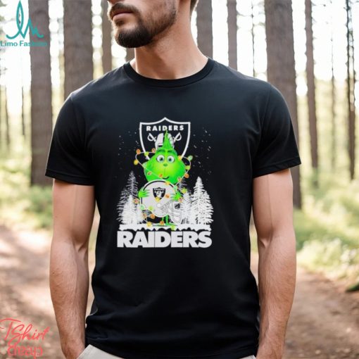 The Baby Grinch hugging Las Vegas Raiders helmet snowy forest Christmas shirt