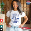 John Denver sitting in field white retro shirt